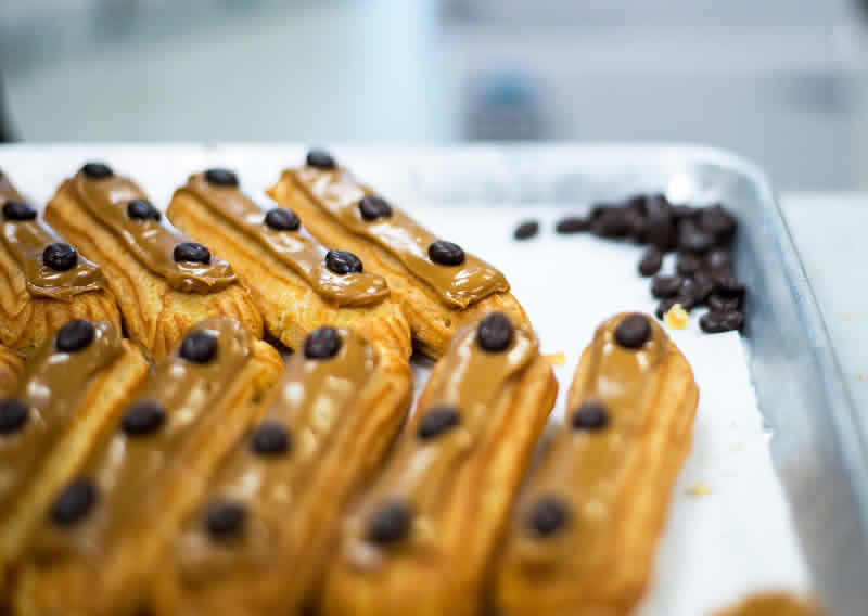 Chocolate eclairs on display tray