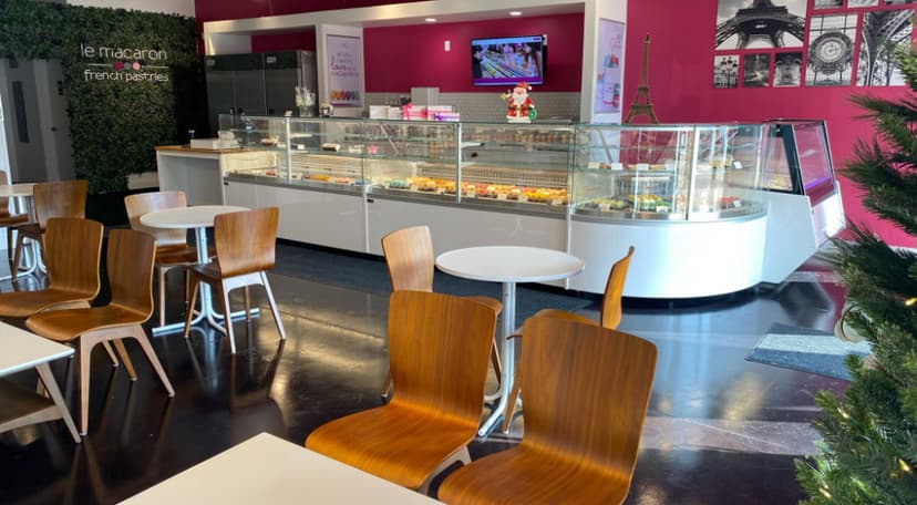 Le Macaron interior with seating, display case, and Eiffel Tower decor